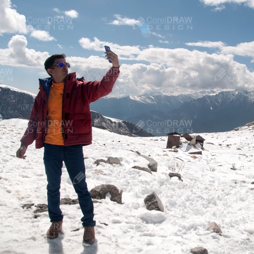 Young Man taking Selfie In Snow Mountain Stock Photos