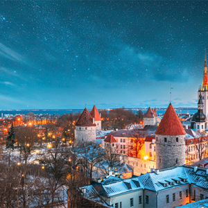 Tallinn, Estonia. Night Starry Sky Above Old Castle Walls Architecture. Cityscape Skyline In Old
