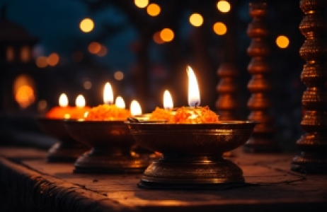 A lit candle on the ground with colorful decor, diwali stock images, realistic stock photos